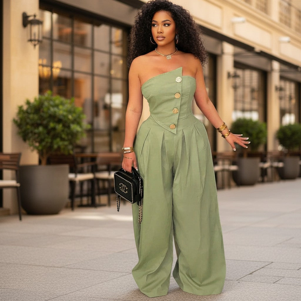 Model wearing a SHES & COMPANY BOUTIQUE army green strapless wide-leg jumpsuit with decorative buttons on a city street.